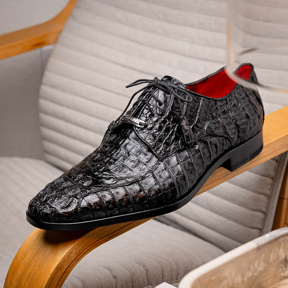 A pair of Marco Di Milano Apricena Black luxury men's dress shoes in genuine caiman crocodile leather with red interior lining and tan leather soles—one upright, the other lying stylishly on its side.