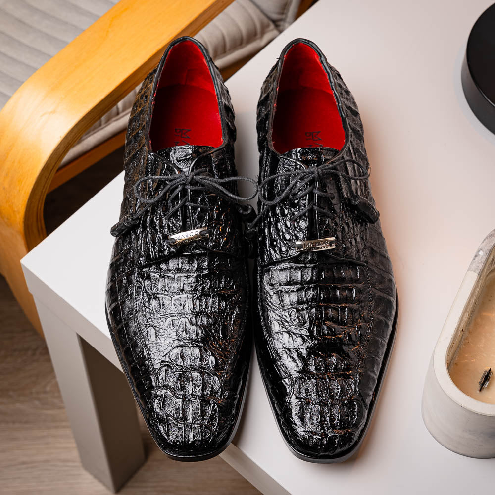 A pair of Marco Di Milano Apricena Black luxury men's dress shoes in genuine caiman crocodile leather with red interior lining and tan leather soles—one upright, the other lying stylishly on its side.