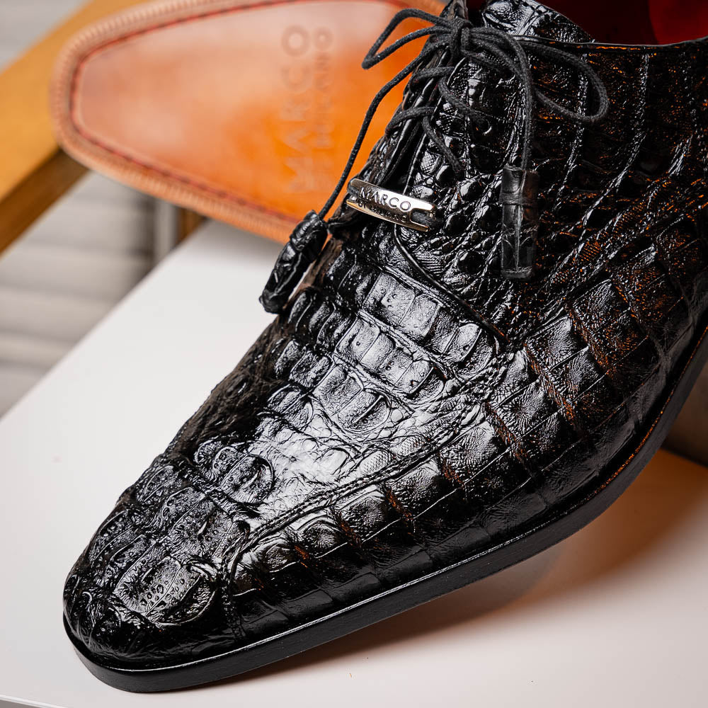A pair of Marco Di Milano Apricena Black luxury men's dress shoes in genuine caiman crocodile leather with red interior lining and tan leather soles—one upright, the other lying stylishly on its side.