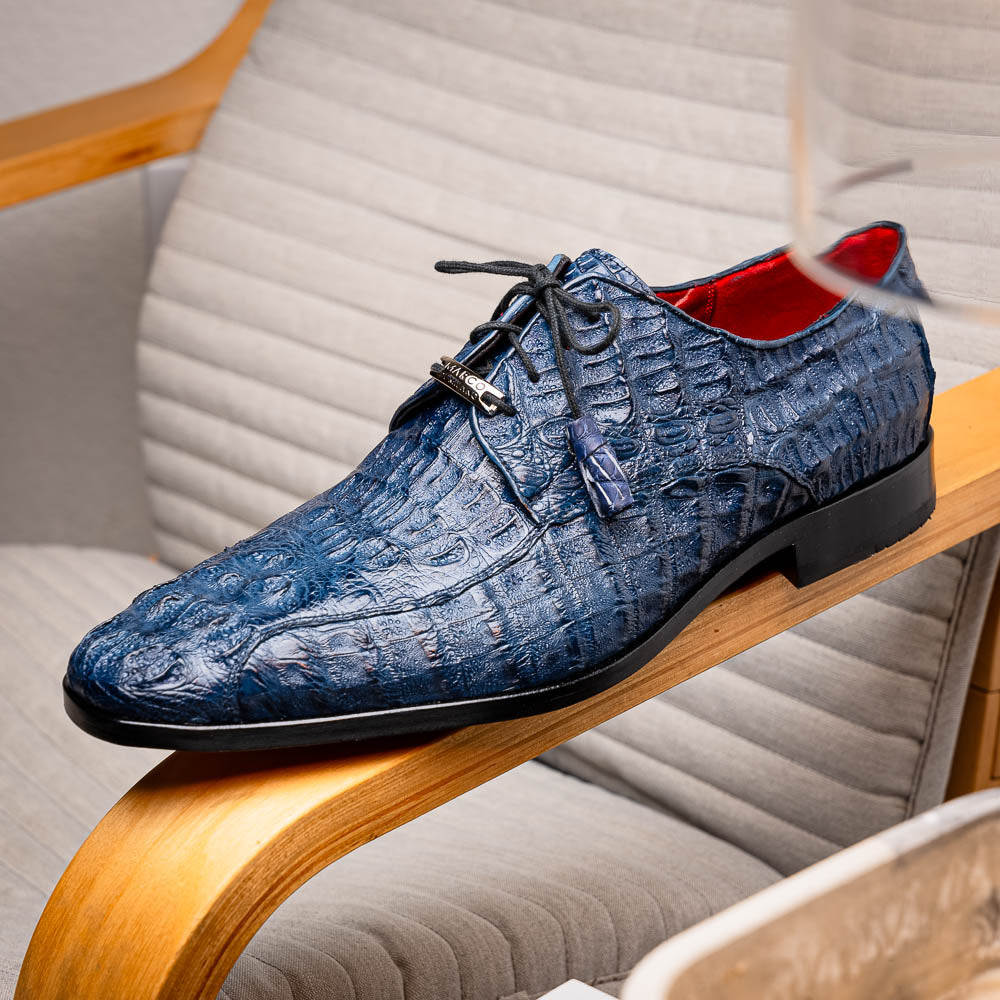 The Apricena Navy by Marco Di Milano are blue textured luxury men's dress shoes with black laces, red interior lining, and branded tan leather soles—crafted to evoke the refined look of genuine caiman crocodile shoes.
