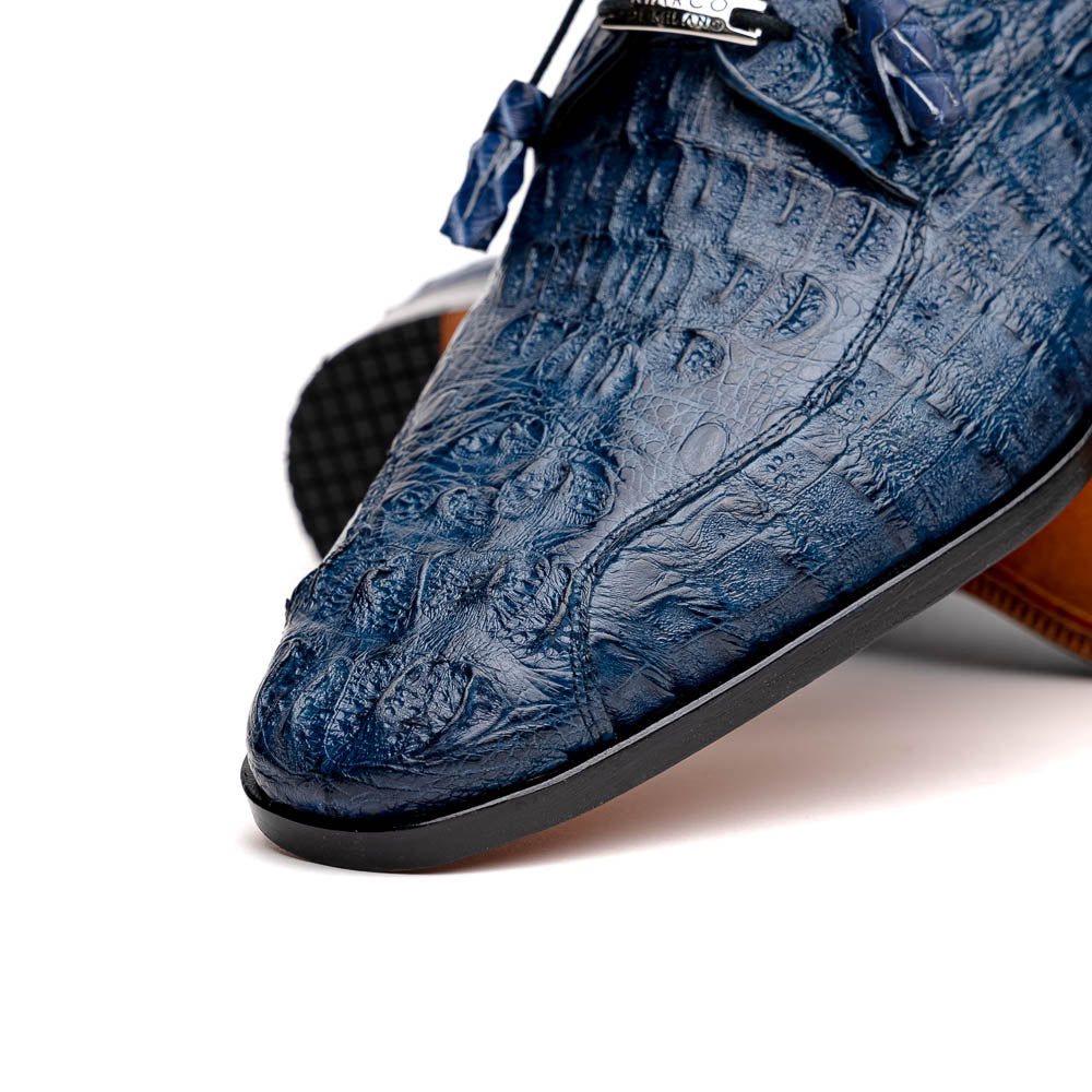 The Apricena Navy by Marco Di Milano are blue textured luxury men's dress shoes with black laces, red interior lining, and branded tan leather soles—crafted to evoke the refined look of genuine caiman crocodile shoes.