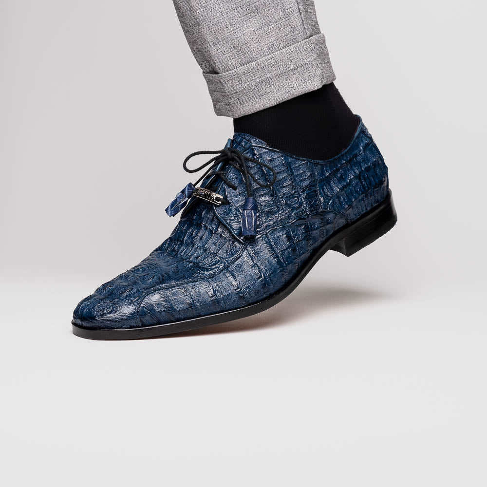 The Apricena Navy by Marco Di Milano are blue textured luxury men's dress shoes with black laces, red interior lining, and branded tan leather soles—crafted to evoke the refined look of genuine caiman crocodile shoes.