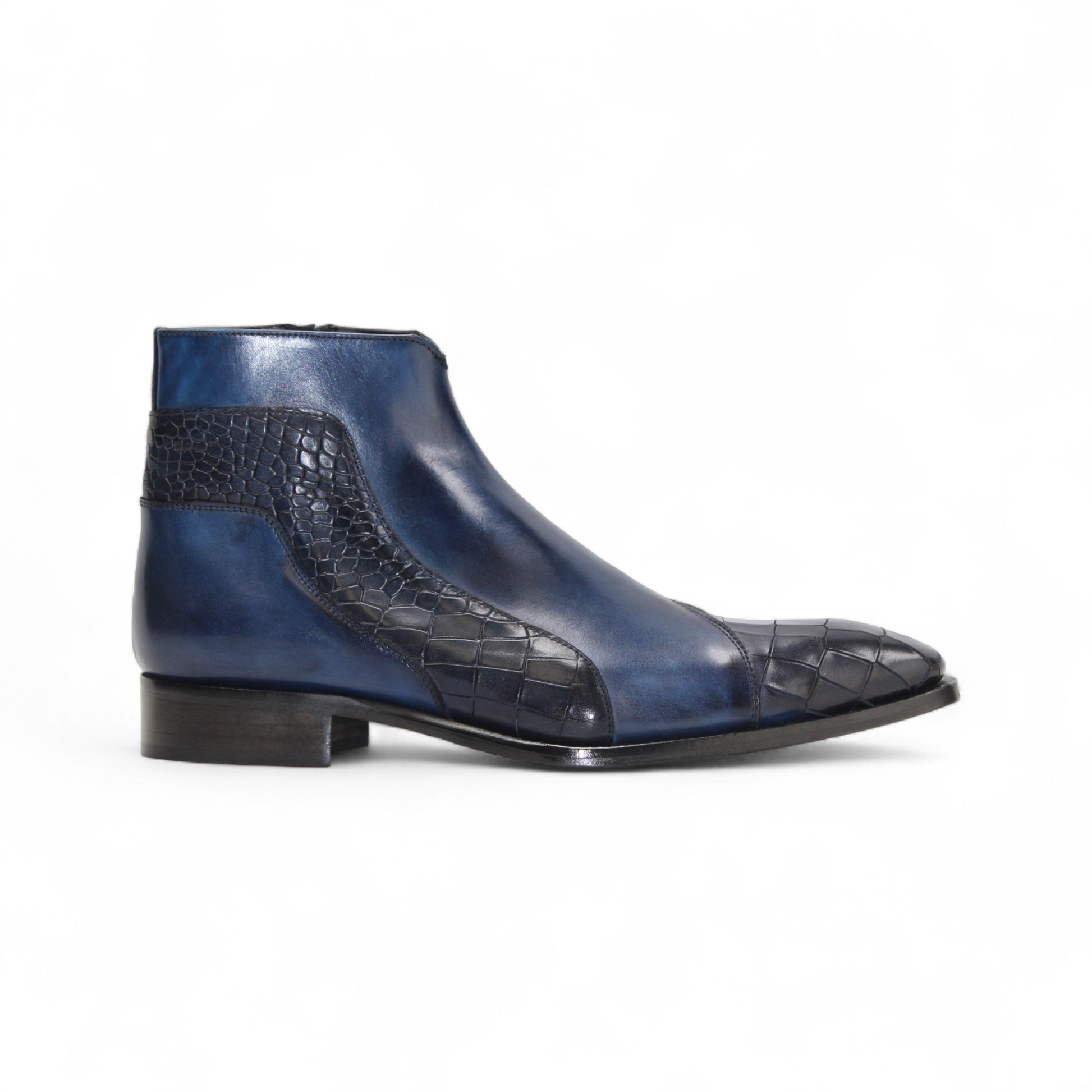 The Duca Di Matiste Duca Aprilia Navy is a genuine leather ankle boot in blue with black textured overlays, a low heel, and almond-shaped toe, shown on a white background.