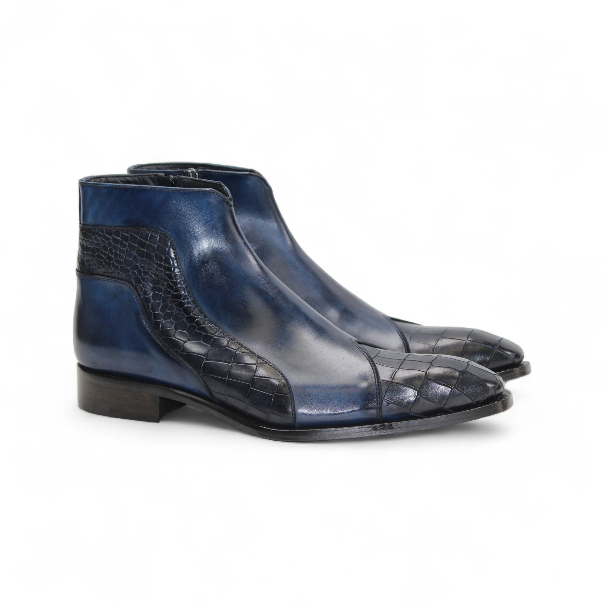 The Duca Di Matiste Duca Aprilia Navy is a genuine leather ankle boot in blue with black textured overlays, a low heel, and almond-shaped toe, shown on a white background.