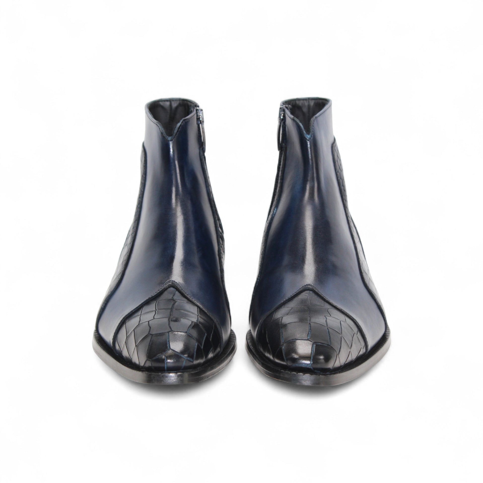 The Duca Di Matiste Duca Aprilia Navy is a genuine leather ankle boot in blue with black textured overlays, a low heel, and almond-shaped toe, shown on a white background.