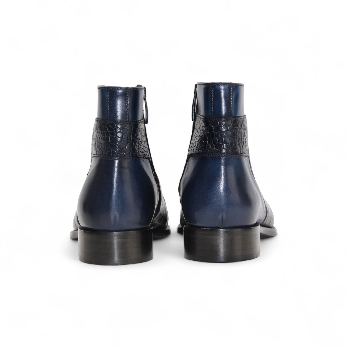 The Duca Di Matiste Duca Aprilia Navy is a genuine leather ankle boot in blue with black textured overlays, a low heel, and almond-shaped toe, shown on a white background.