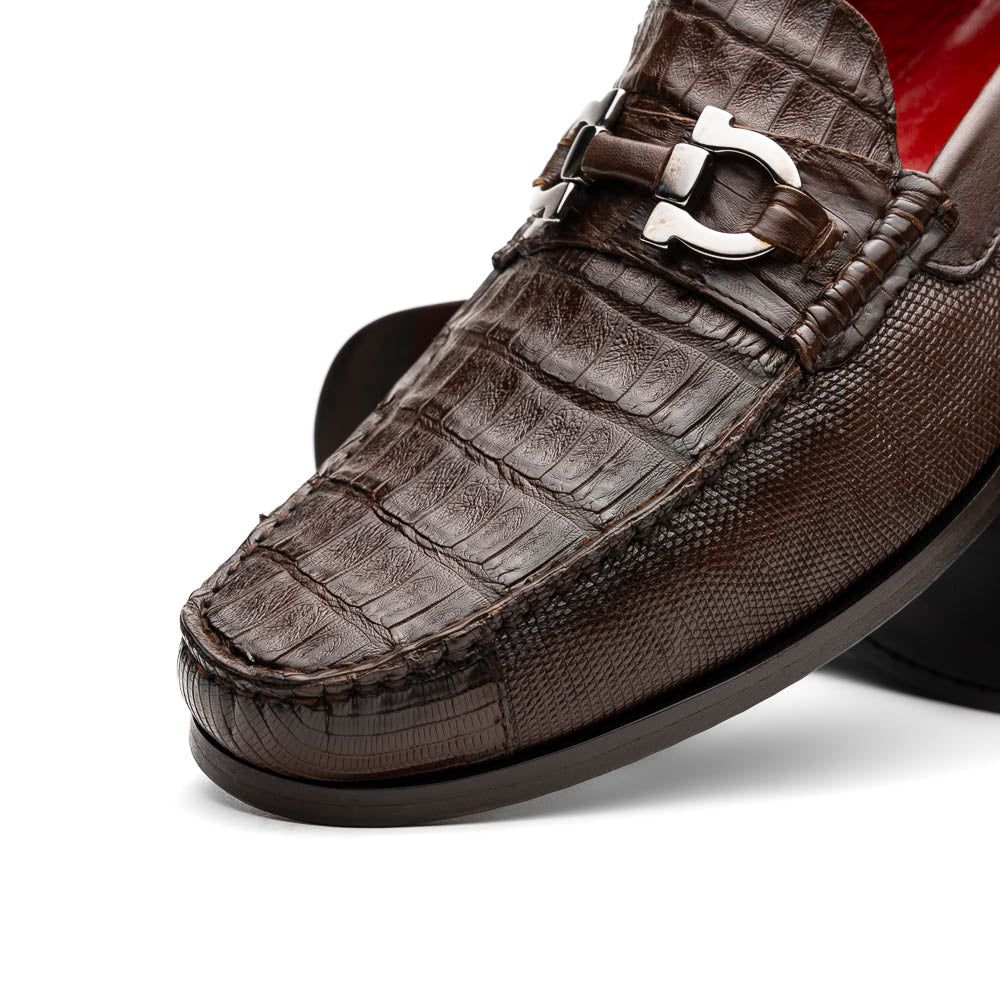 Introducing the Adro Brown by Marco Di Milano—crafted in brown leather with crocodile texture, silver buckle, red interior lining, and signature sole logo. A luxurious choice for those who value genuine exotic design.