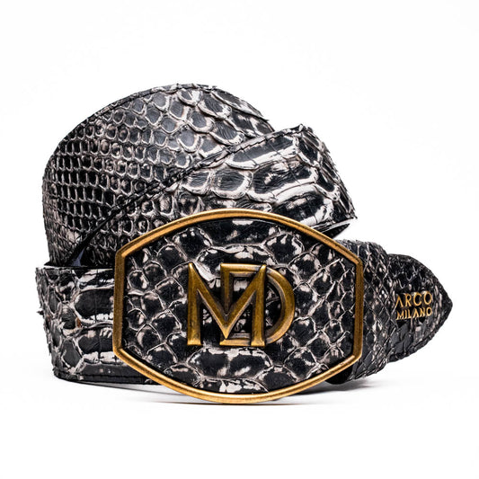 The Arkansas Belt Antique Newspaper by Marco Di Milano features genuine python skin in black and silver, a large gold “MD” buckle, and “MARCO MILANO” text on the tip, fusing exotic style with luxury craftsmanship.