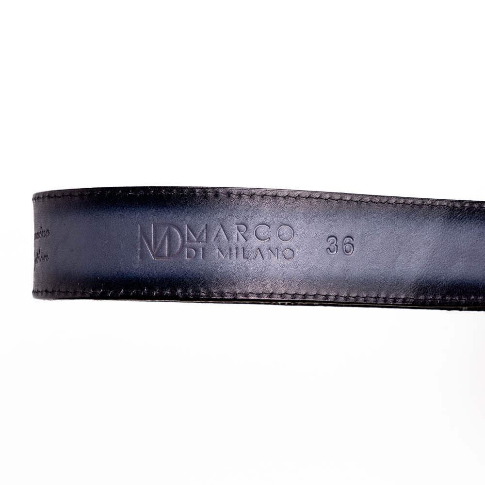 The Arkansas Belt Antique Newspaper by Marco Di Milano features genuine python skin in black and silver, a large gold “MD” buckle, and “MARCO MILANO” text on the tip, fusing exotic style with luxury craftsmanship.