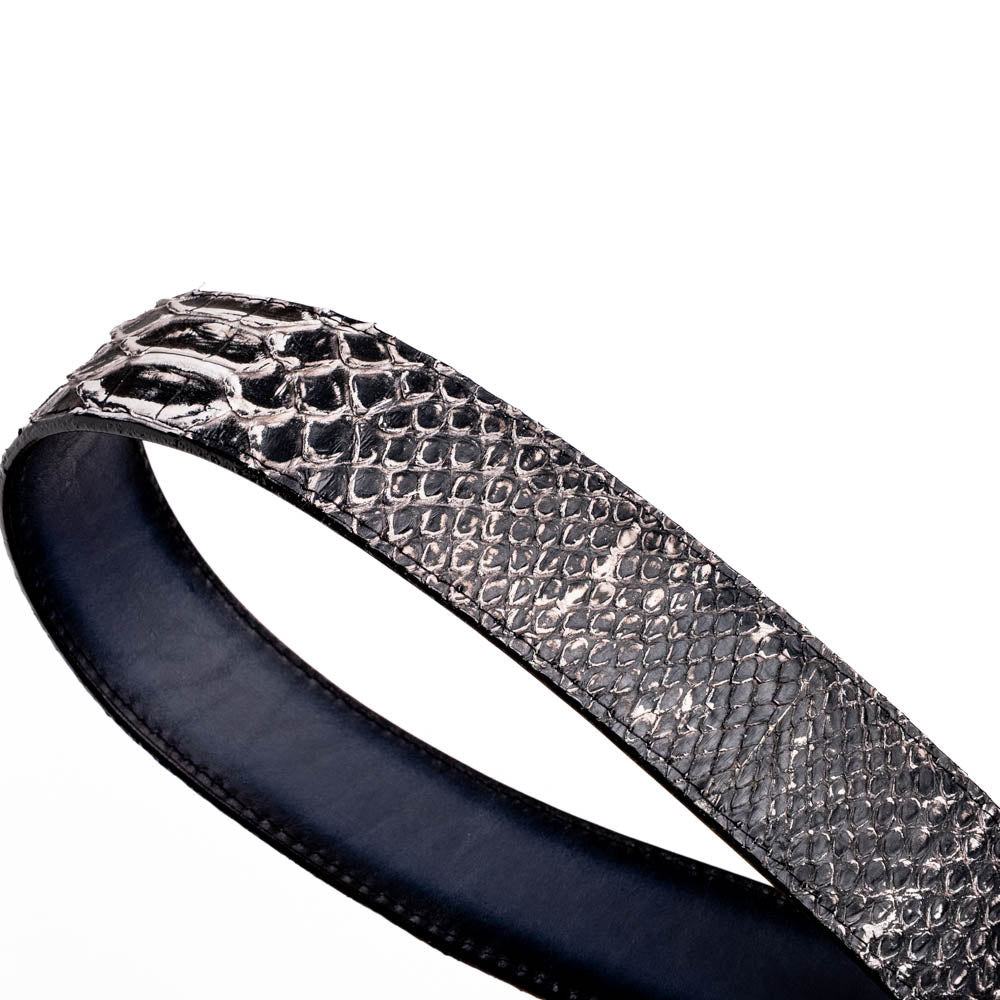 The Arkansas Belt Antique Newspaper by Marco Di Milano features genuine python skin in black and silver, a large gold “MD” buckle, and “MARCO MILANO” text on the tip, fusing exotic style with luxury craftsmanship.