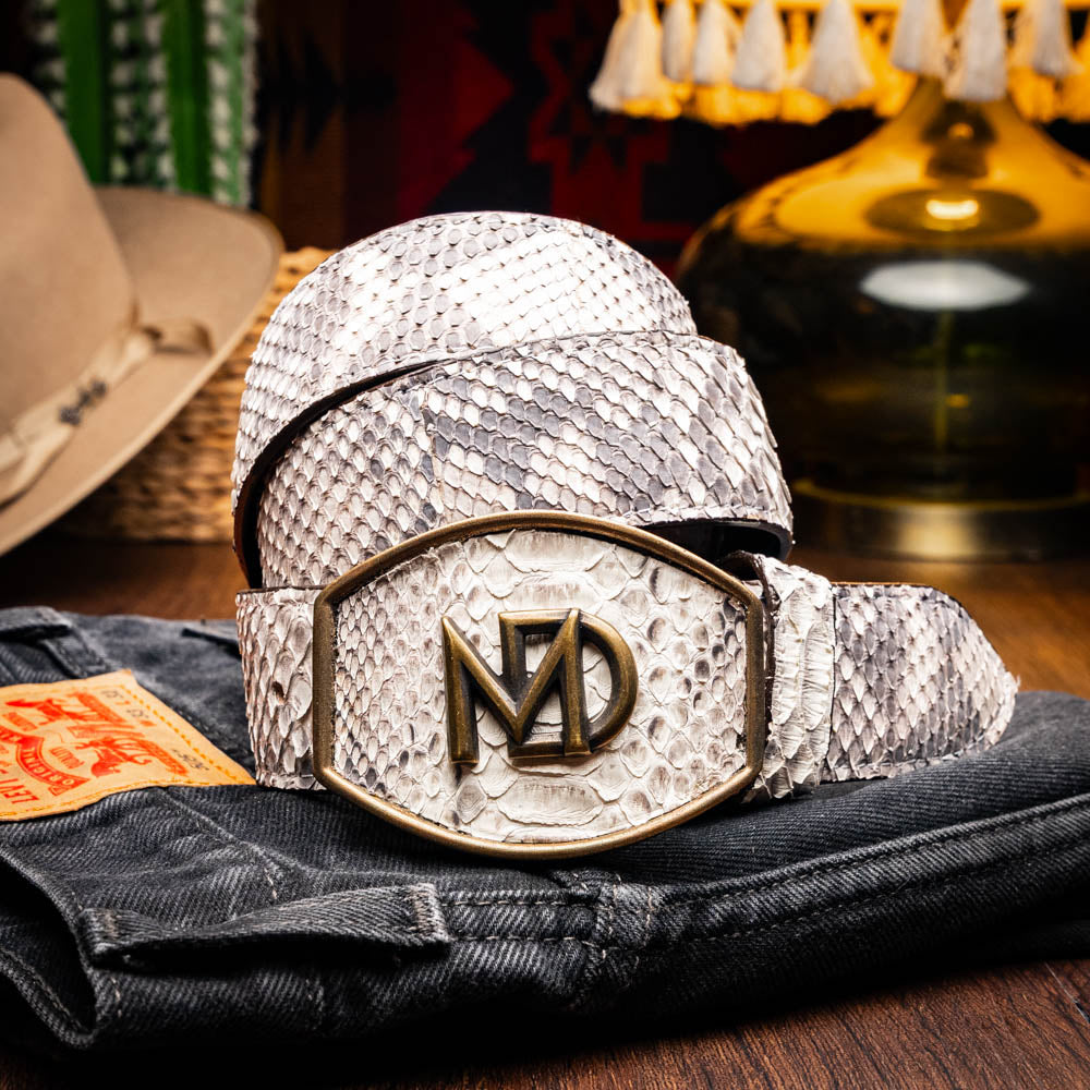The Arkansas Belt Natural by Marco Di Milano is a handcrafted exotic accessory with a snakeskin pattern and a bold gold "MD" logo buckle at the center.