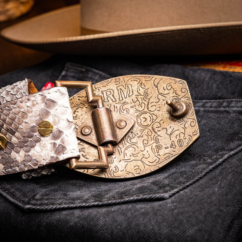 The Arkansas Belt Natural by Marco Di Milano is a handcrafted exotic accessory with a snakeskin pattern and a bold gold "MD" logo buckle at the center.