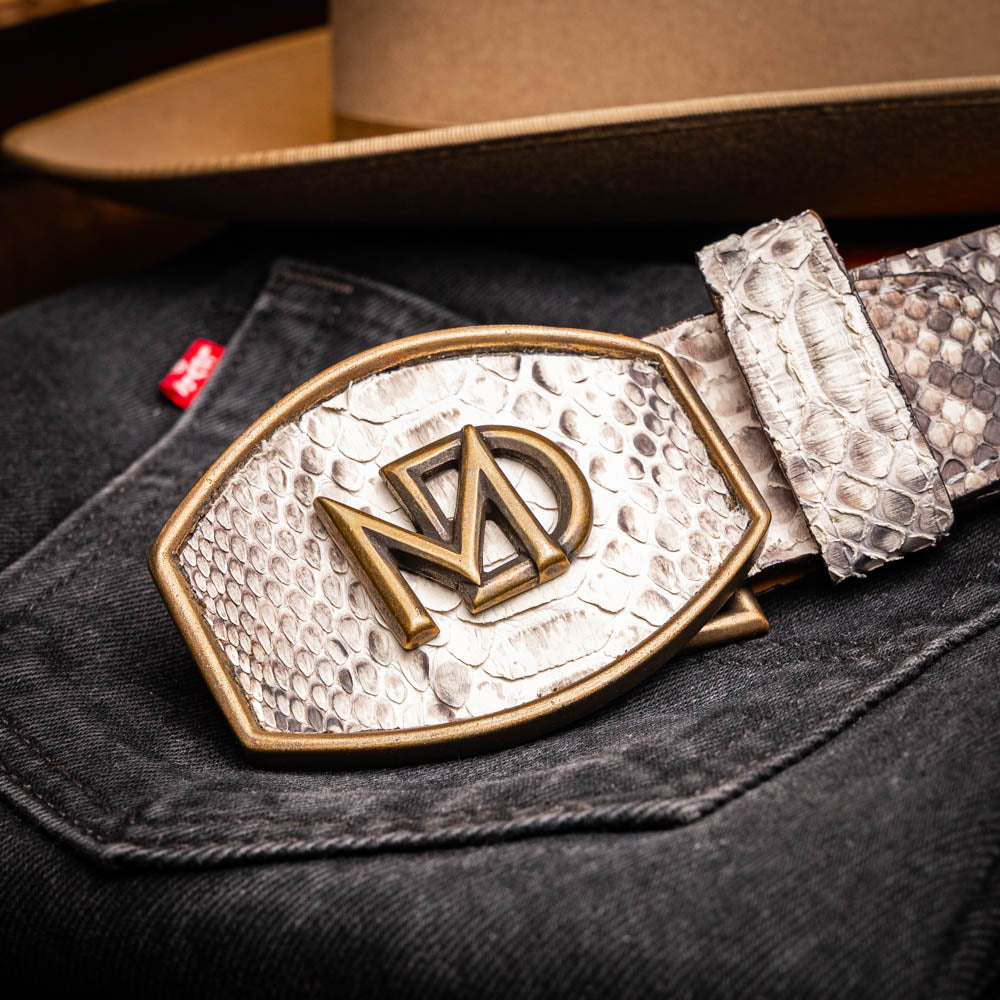 The Arkansas Belt Natural by Marco Di Milano is a handcrafted exotic accessory with a snakeskin pattern and a bold gold "MD" logo buckle at the center.