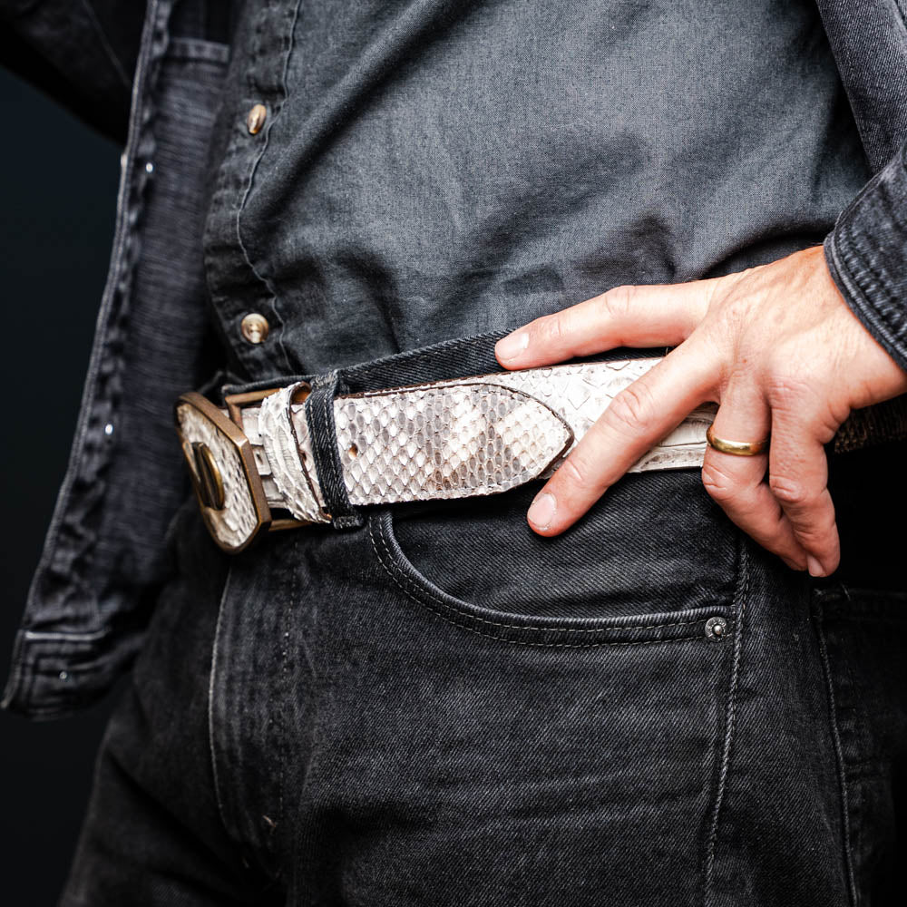 The Arkansas Belt Natural by Marco Di Milano is a handcrafted exotic accessory with a snakeskin pattern and a bold gold "MD" logo buckle at the center.