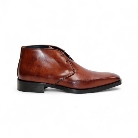 The Firmani Asher Brandy by Firmani is a brown leather dress boot with Italian craftsmanship, two eyelets, a low heel, and a black sole, shown in profile on a plain white background.