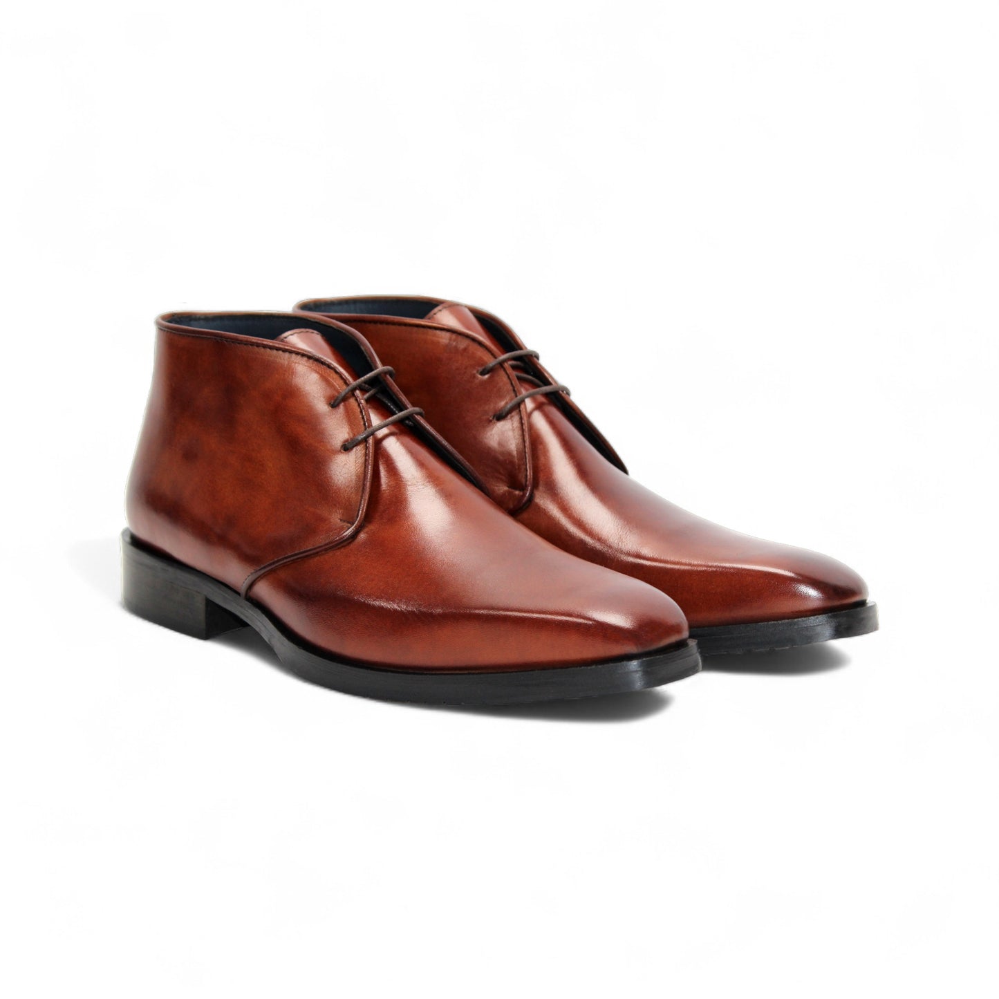 The Firmani Asher Brandy by Firmani is a brown leather dress boot with Italian craftsmanship, two eyelets, a low heel, and a black sole, shown in profile on a plain white background.