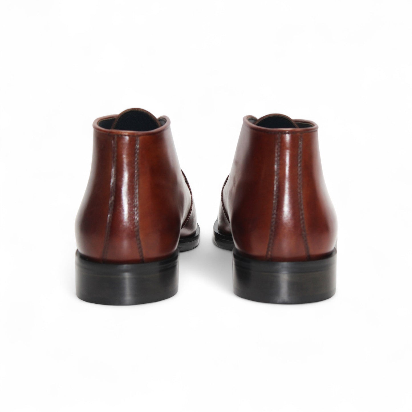 The Firmani Asher Brandy by Firmani is a brown leather dress boot with Italian craftsmanship, two eyelets, a low heel, and a black sole, shown in profile on a plain white background.