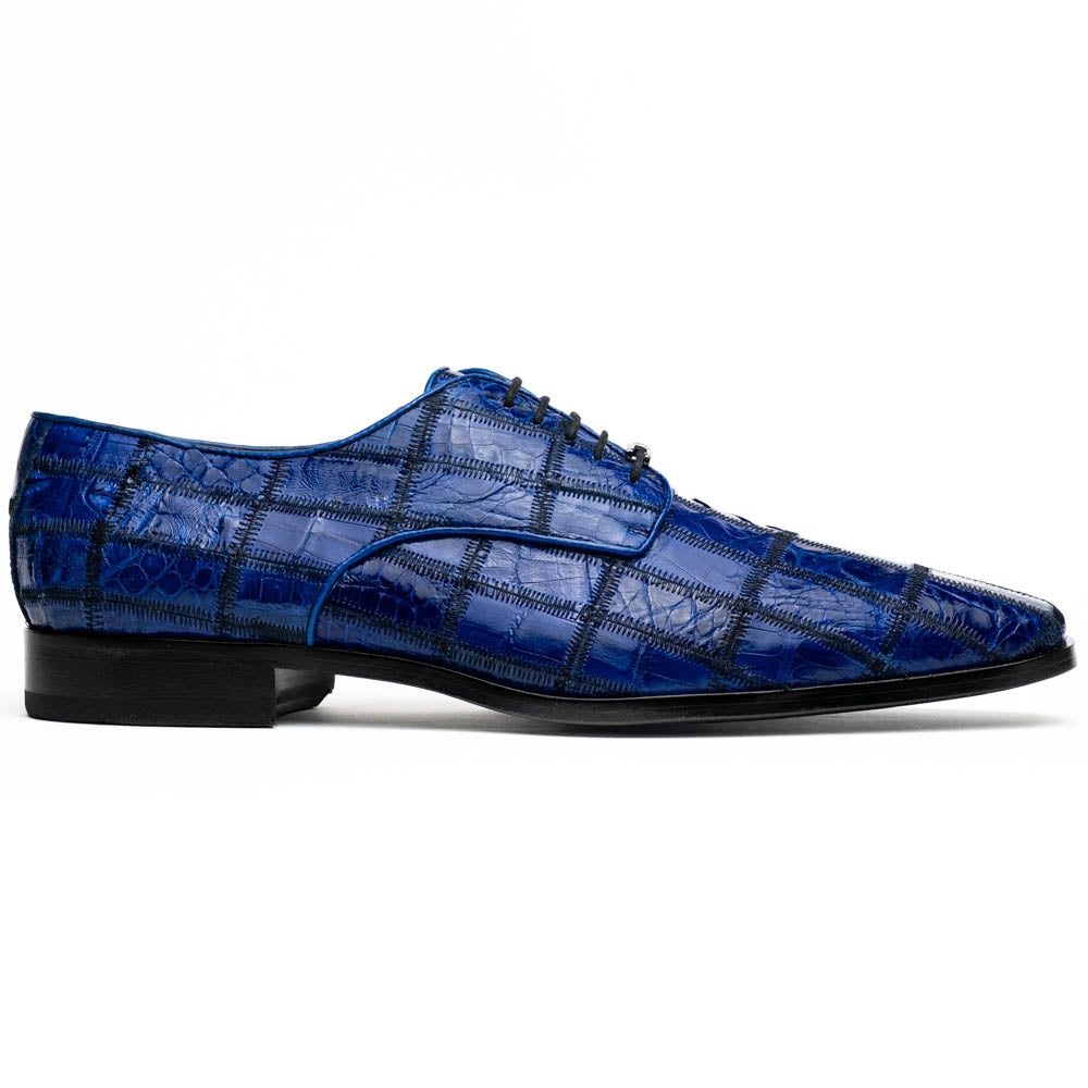The Asti Electric Blue by Marco Di Milano features hand-painted blue crocodile-patterned leather dress shoes—one upright, one on its side showing the sole—highlighting genuine exotic craftsmanship and luxury style.