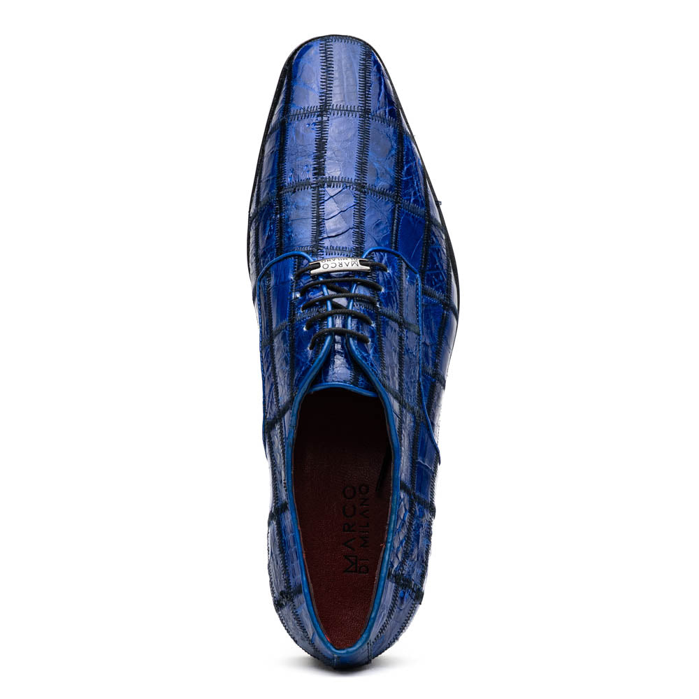 The Asti Electric Blue by Marco Di Milano features hand-painted blue crocodile-patterned leather dress shoes—one upright, one on its side showing the sole—highlighting genuine exotic craftsmanship and luxury style.