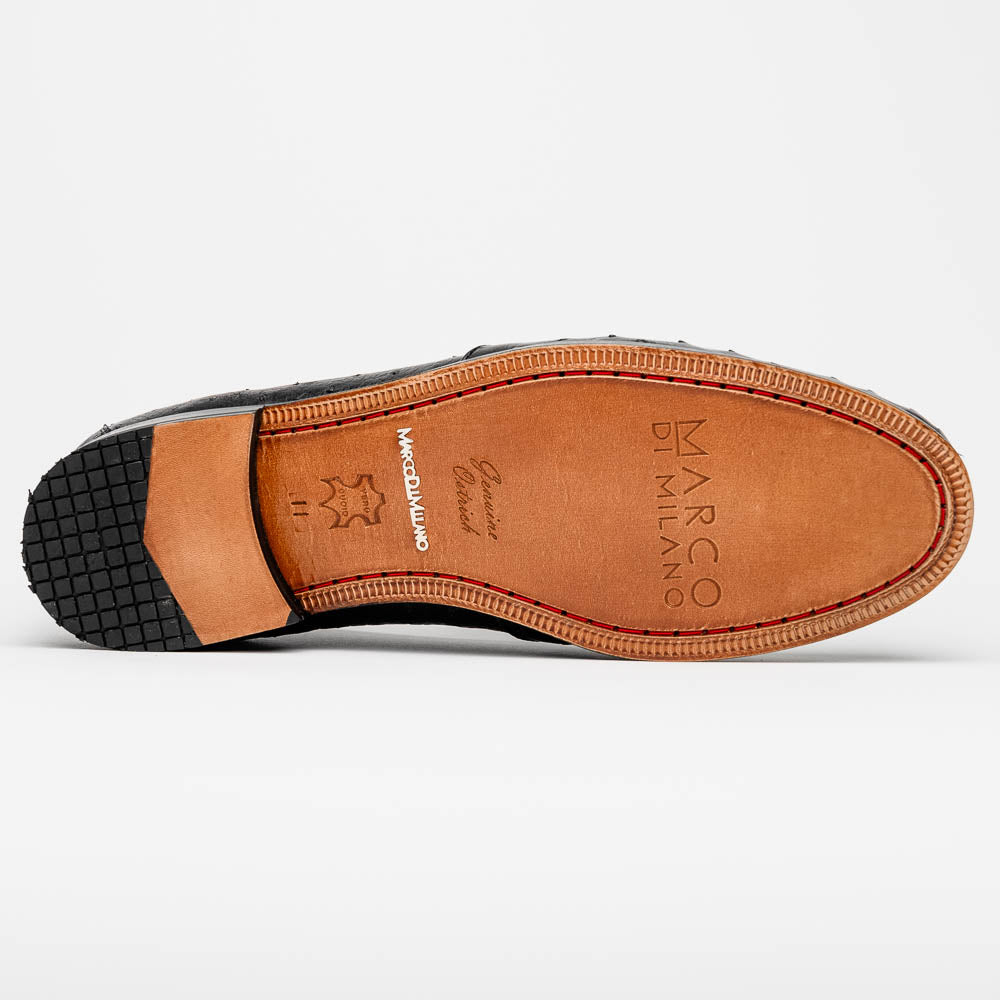 The Aubiere Black by Marco Di Milano are luxury men's tassel loafers in black genuine ostrich leather, shown with one shoe upright and the other displaying a tan sole embossed with the Marco Di Milano logo.