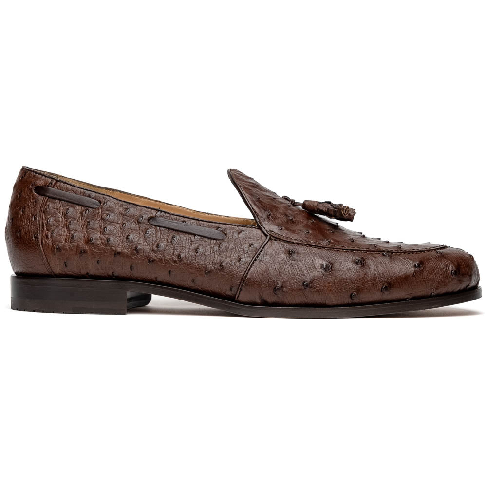 A pair of Marco Di Milano Aubiere Brown men's loafers, featuring brown leather with a textured pattern and tassel detail; one shoe stands upright while the other lies on its side showing the branded sole.