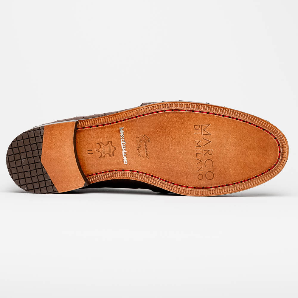 A pair of Marco Di Milano Aubiere Brown men's loafers, featuring brown leather with a textured pattern and tassel detail; one shoe stands upright while the other lies on its side showing the branded sole.
