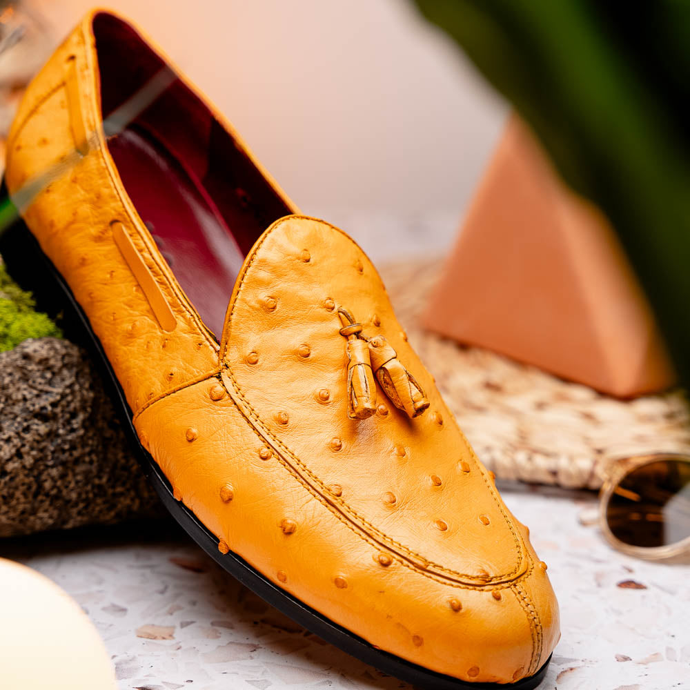 The Aubiere Buttercup by Marco Di Milano are yellow ostrich tassel loafers with red interior lining and branded leather soles, expertly crafted from genuine ostrich, presented against a white background.