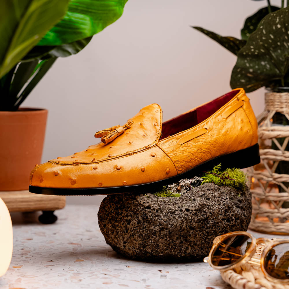 The Aubiere Buttercup by Marco Di Milano are yellow ostrich tassel loafers with red interior lining and branded leather soles, expertly crafted from genuine ostrich, presented against a white background.