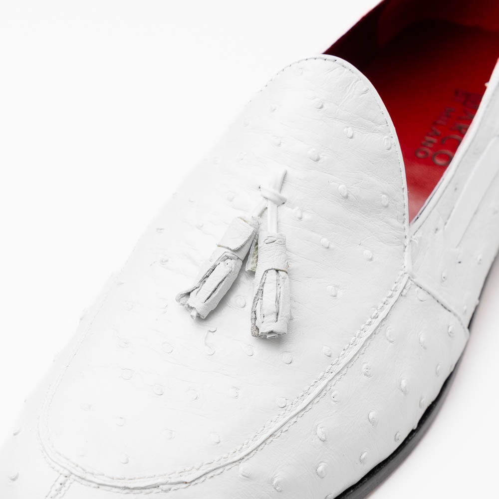 A pair of luxury men’s loafers—Marco Di Milano Aubiere White—crafted in textured white leather with ostrich tassels, red interior lining, tan soles; one shoe rests on its side showing the “Marco Di Milano” logo.