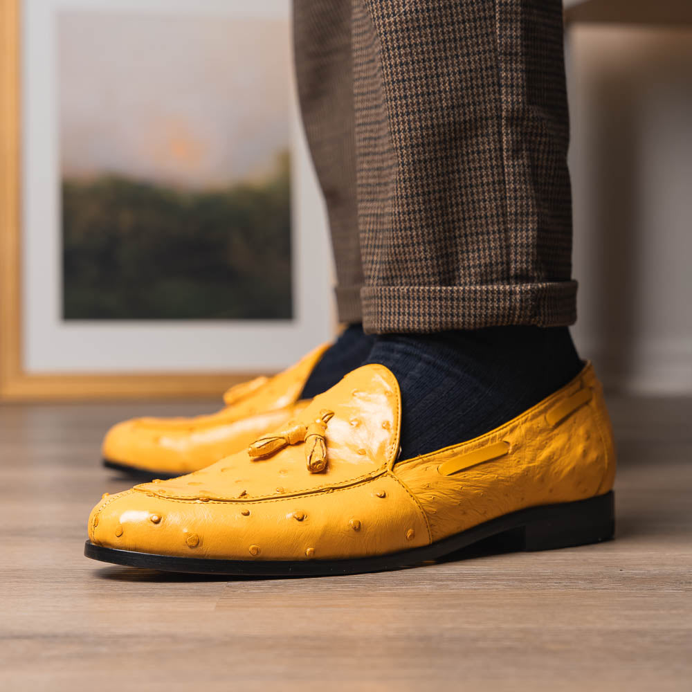 The Aubiere Buttercup by Marco Di Milano are yellow ostrich tassel loafers with red interior lining and branded leather soles, expertly crafted from genuine ostrich, presented against a white background.