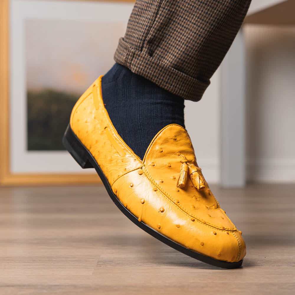 The Aubiere Buttercup by Marco Di Milano are yellow ostrich tassel loafers with red interior lining and branded leather soles, expertly crafted from genuine ostrich, presented against a white background.
