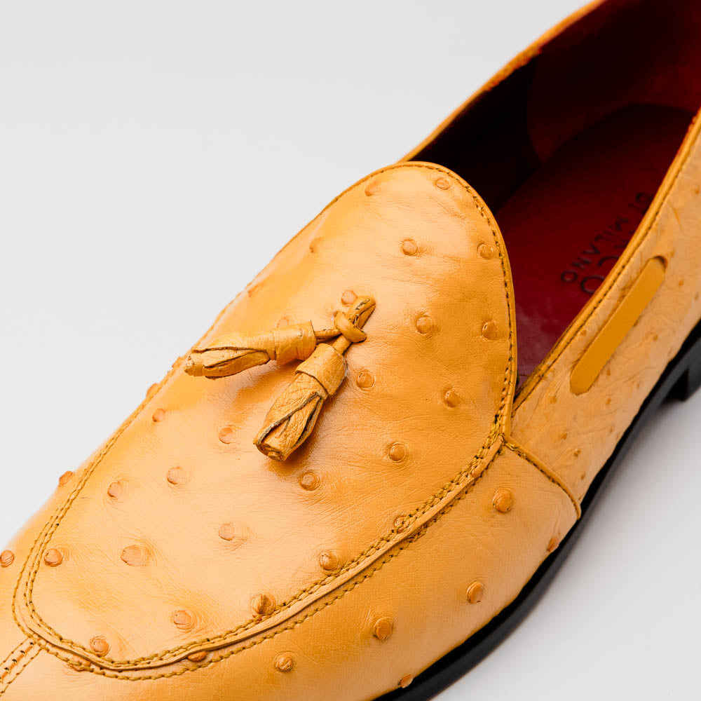The Aubiere Buttercup by Marco Di Milano are yellow ostrich tassel loafers with red interior lining and branded leather soles, expertly crafted from genuine ostrich, presented against a white background.