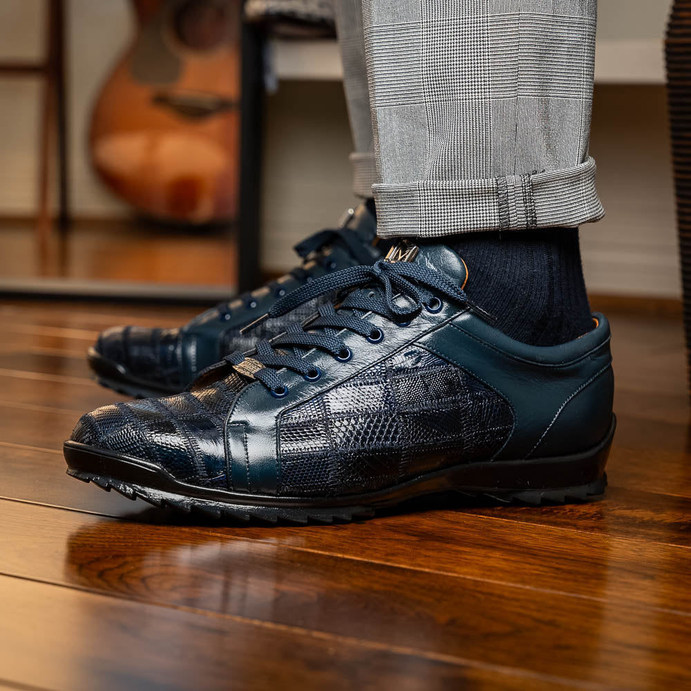 Bari Navy by Marco Di Milano: dark blue lace-up sneakers with a hand-painted finish, textured pattern, and rubber soles—one upright, one leaning. Enjoy luxury footwear designed for ultimate style and comfort.