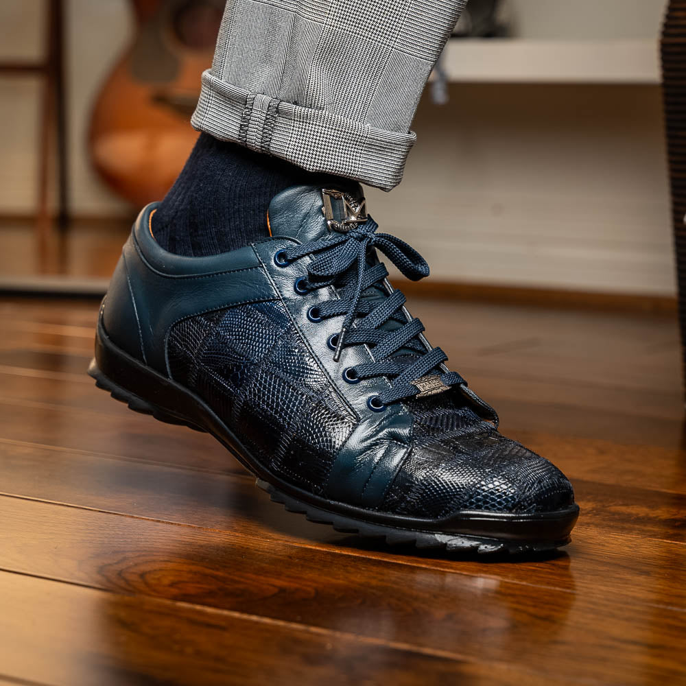 Bari Navy by Marco Di Milano: dark blue lace-up sneakers with a hand-painted finish, textured pattern, and rubber soles—one upright, one leaning. Enjoy luxury footwear designed for ultimate style and comfort.