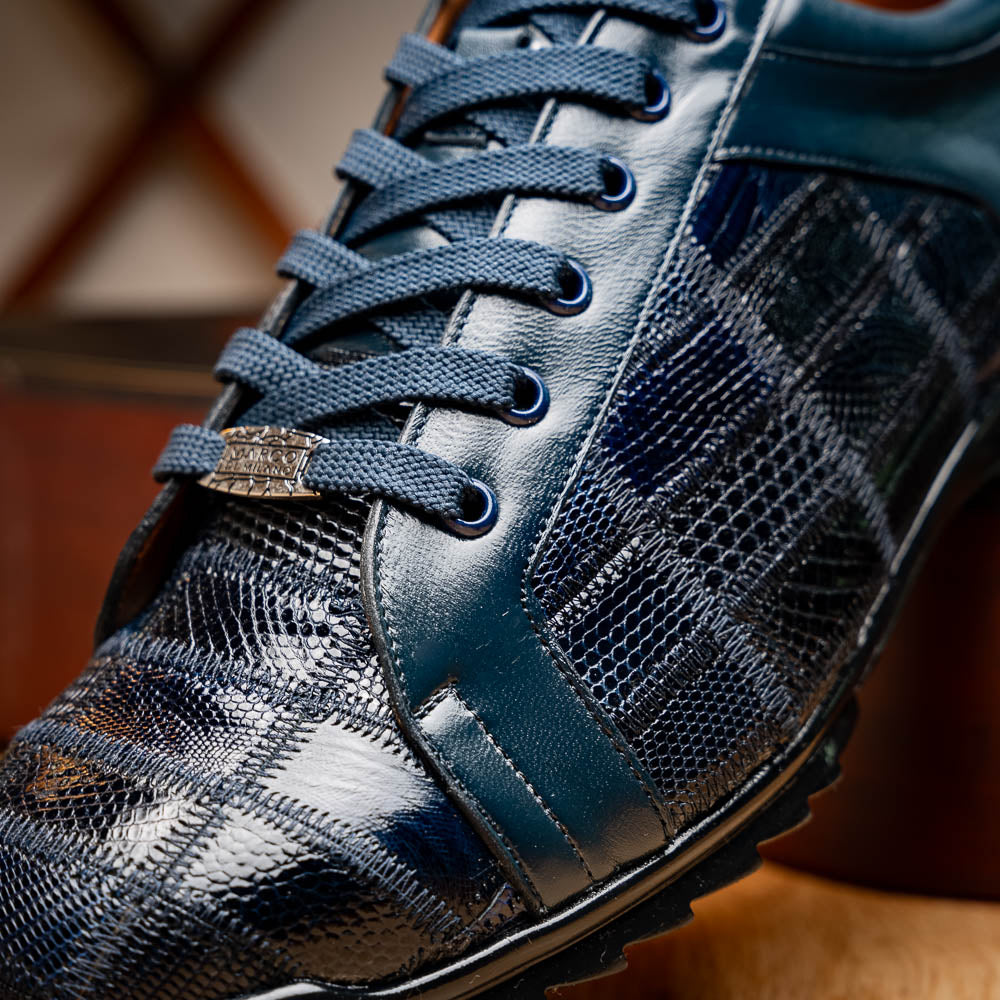 Bari Navy by Marco Di Milano: dark blue lace-up sneakers with a hand-painted finish, textured pattern, and rubber soles—one upright, one leaning. Enjoy luxury footwear designed for ultimate style and comfort.