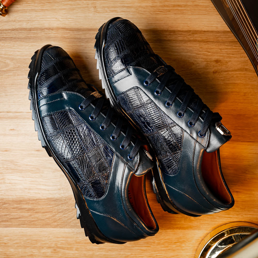 Bari Navy by Marco Di Milano: dark blue lace-up sneakers with a hand-painted finish, textured pattern, and rubber soles—one upright, one leaning. Enjoy luxury footwear designed for ultimate style and comfort.