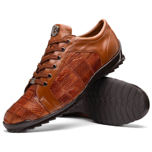 The Marco Di Milano Bari Cognac features brown leather with a hand-painted finish, textured side panels, black laces, and black rubber soles—one shoe propped against the other.