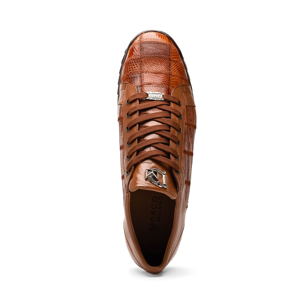The Marco Di Milano Bari Cognac features brown leather with a hand-painted finish, textured side panels, black laces, and black rubber soles—one shoe propped against the other.