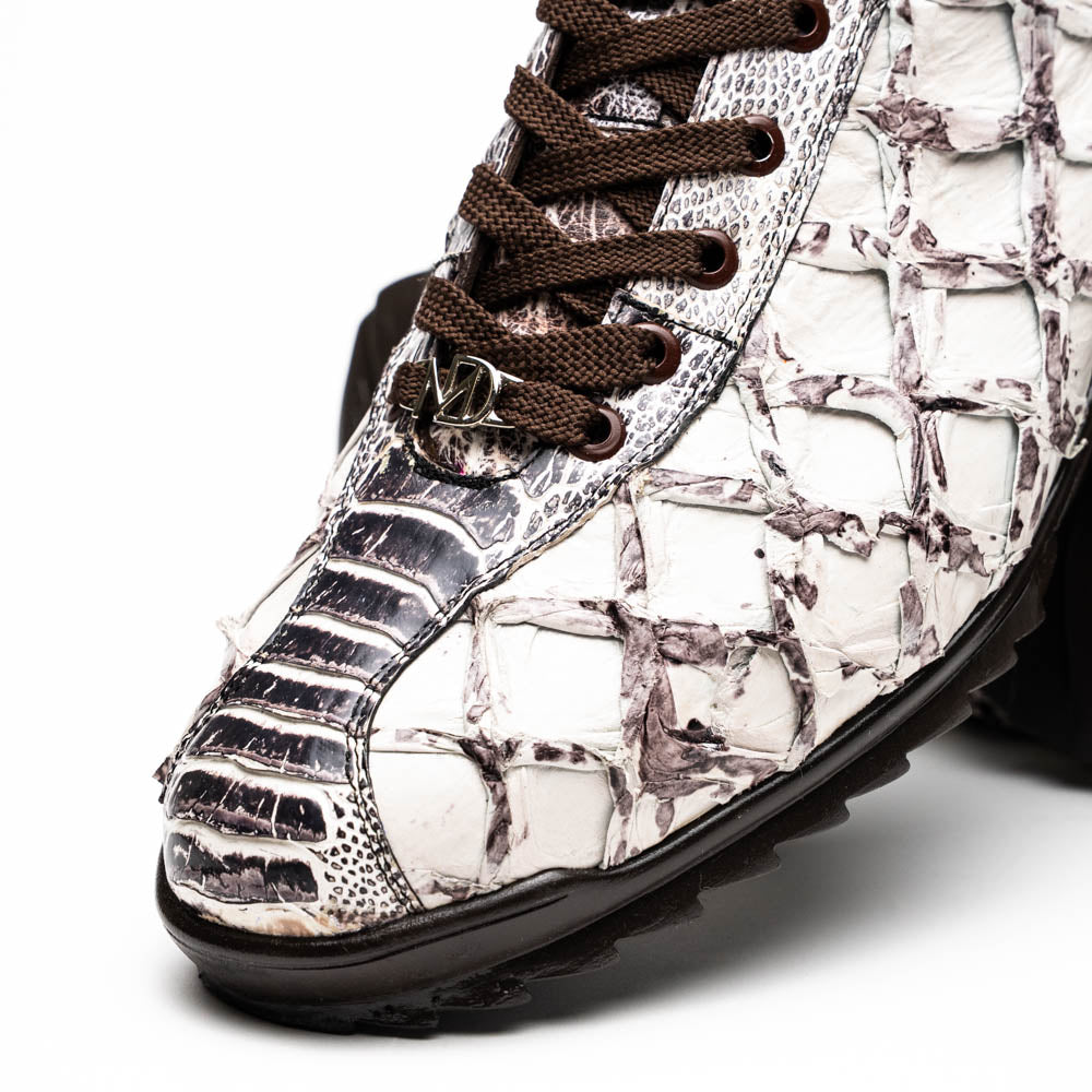 The Marco Di Milano Batistini Newspaper sneakers feature a white and grey crocodile-patterned texture, dark brown laces, and black rubber soles, showcased on a white background.