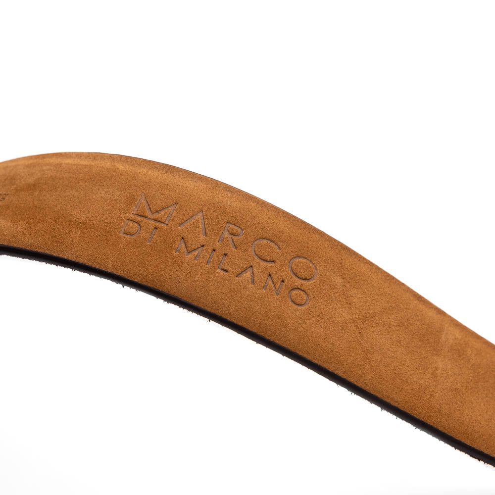 Silvio Belt Black by Marco Di Milano—crafted from black crocodile-embossed leather in the refined style of caiman fuscus-back belts, this belt features meticulous hand-painted finishes and a silver buckle engraved with the Marco Di Milano logo, elegantly coiled on a white background.