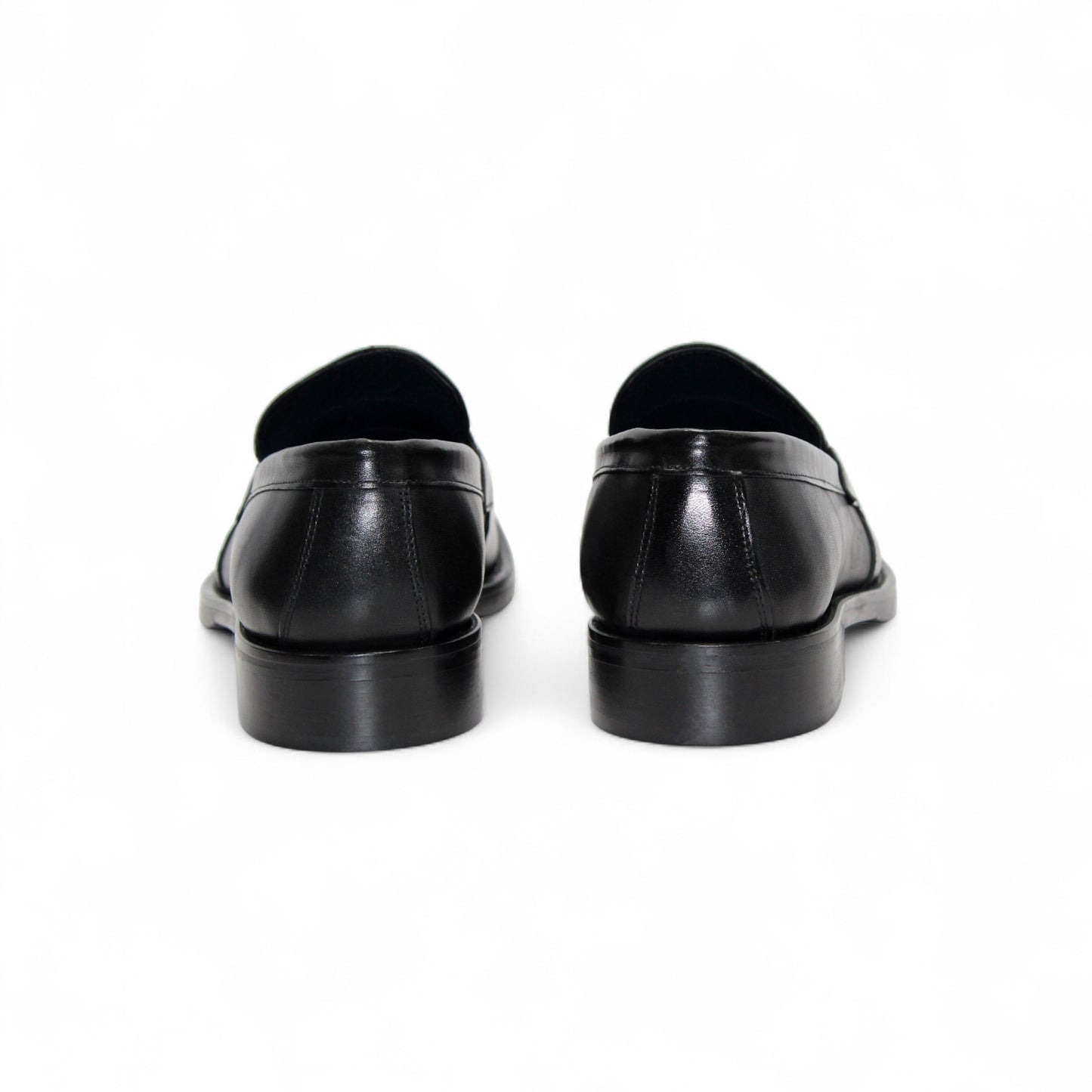 The Firmani Ben Black loafer by Firmani, made from genuine black leather, features a low heel and metal bit detail, shown in side profile against a white background for a classic modern look.