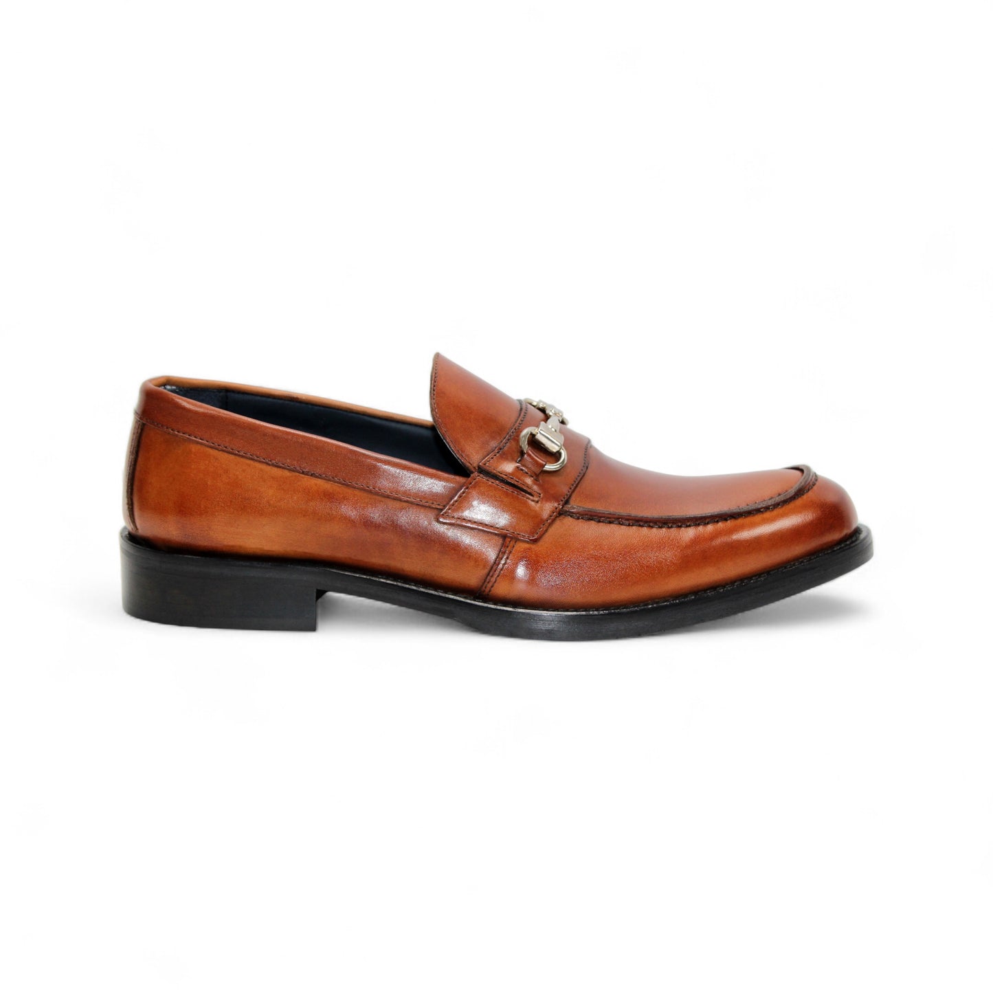 The Firmani Ben Cognac loafer by Firmani features genuine brown leather, a low black heel, and metal bit detail—ideal as a modern dress shoe for any occasion. Displayed on a white background.