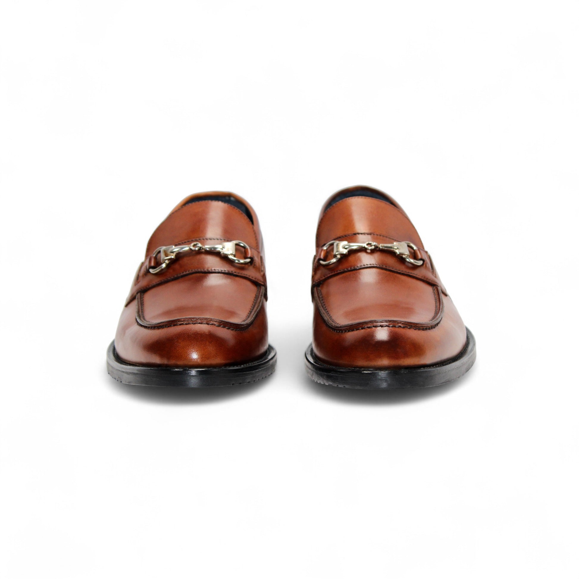 The Firmani Ben Cognac loafer by Firmani features genuine brown leather, a low black heel, and metal bit detail—ideal as a modern dress shoe for any occasion. Displayed on a white background.