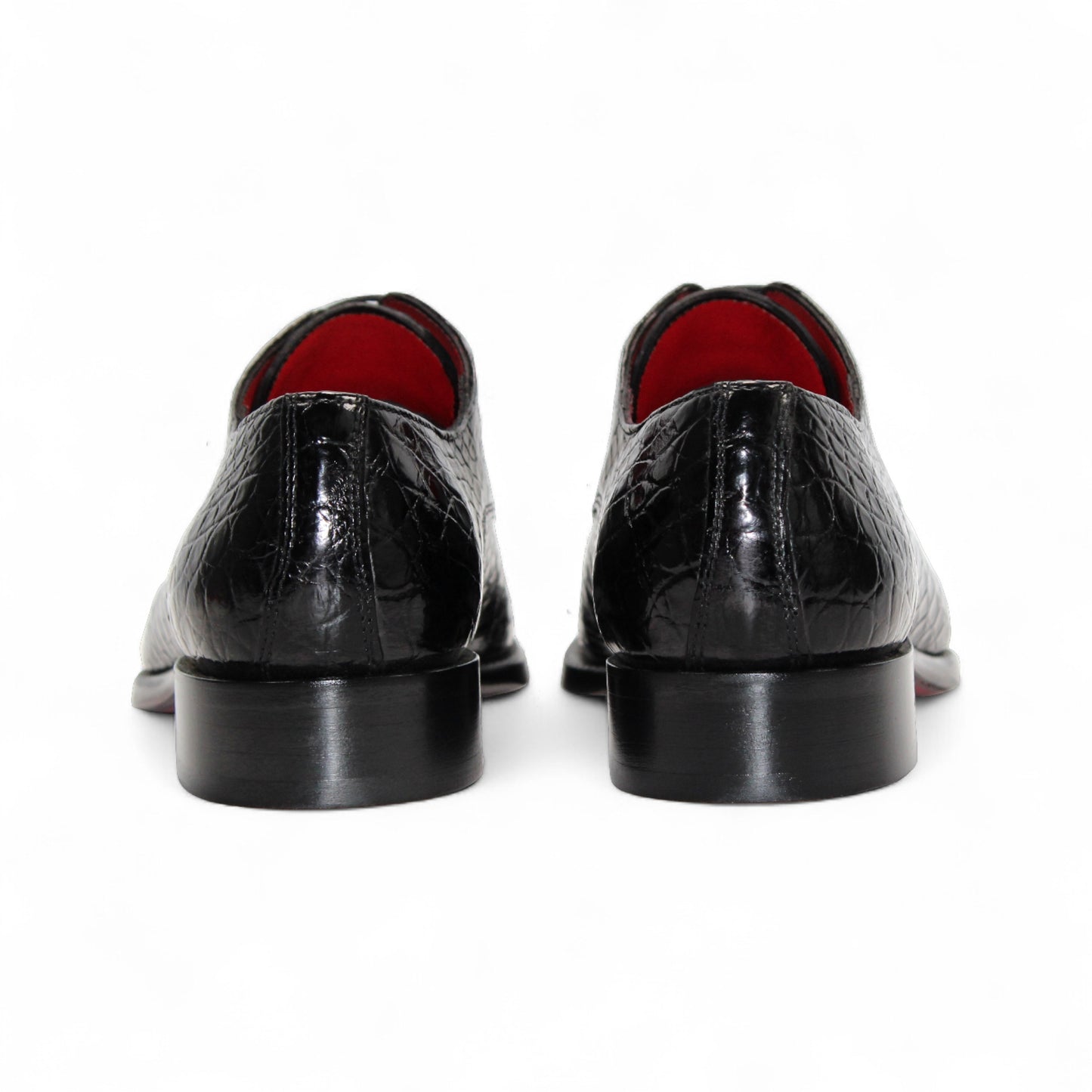 The Fennix Benjamin Black by Fennix of Italy is a glossy black luxury shoe with a crocodile-patterned finish and laces, crafted from genuine alligator leather, shown in a side view against a white background.