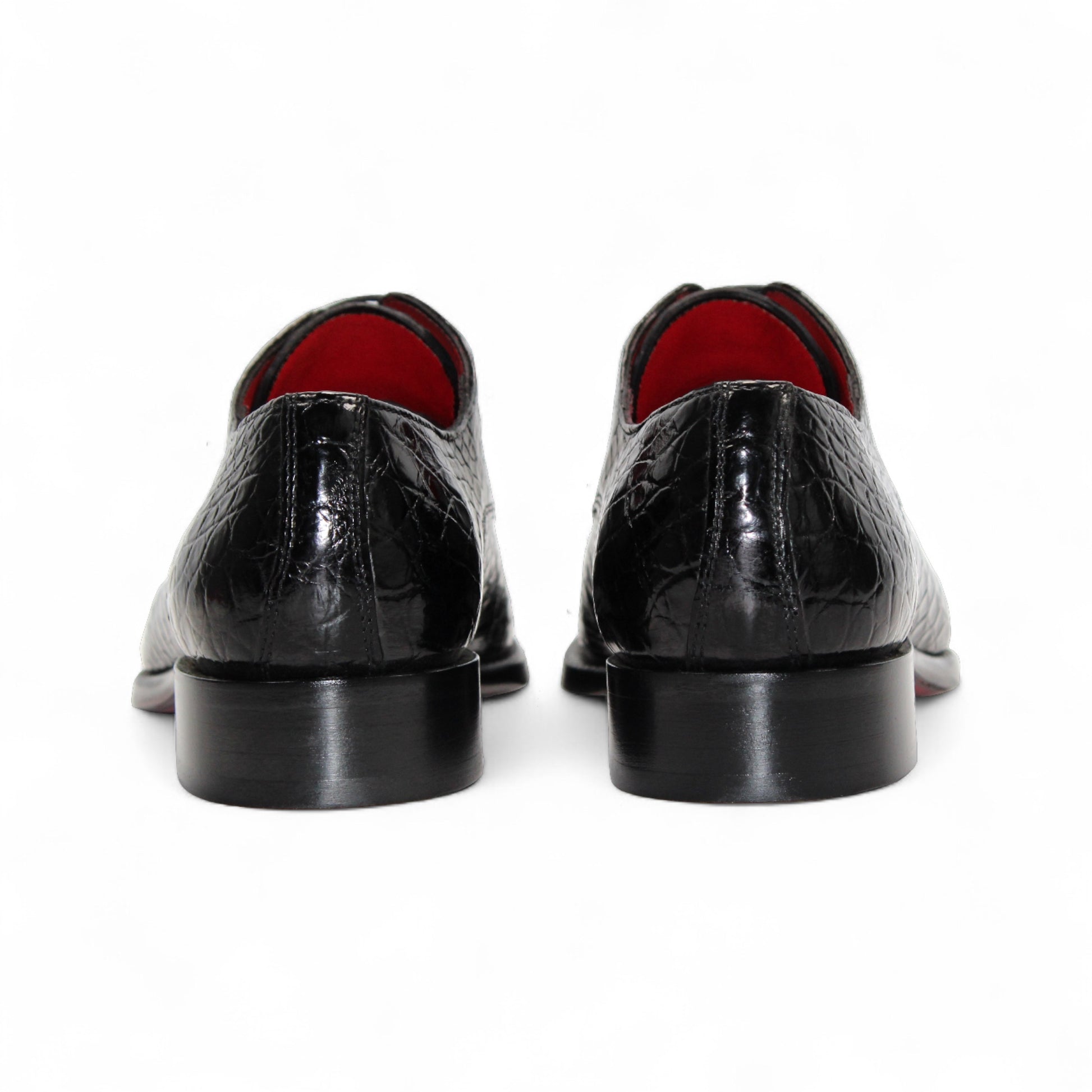 The Fennix Benjamin Black by Fennix of Italy is a glossy black luxury shoe with a crocodile-patterned finish and laces, crafted from genuine alligator leather, shown in a side view against a white background.