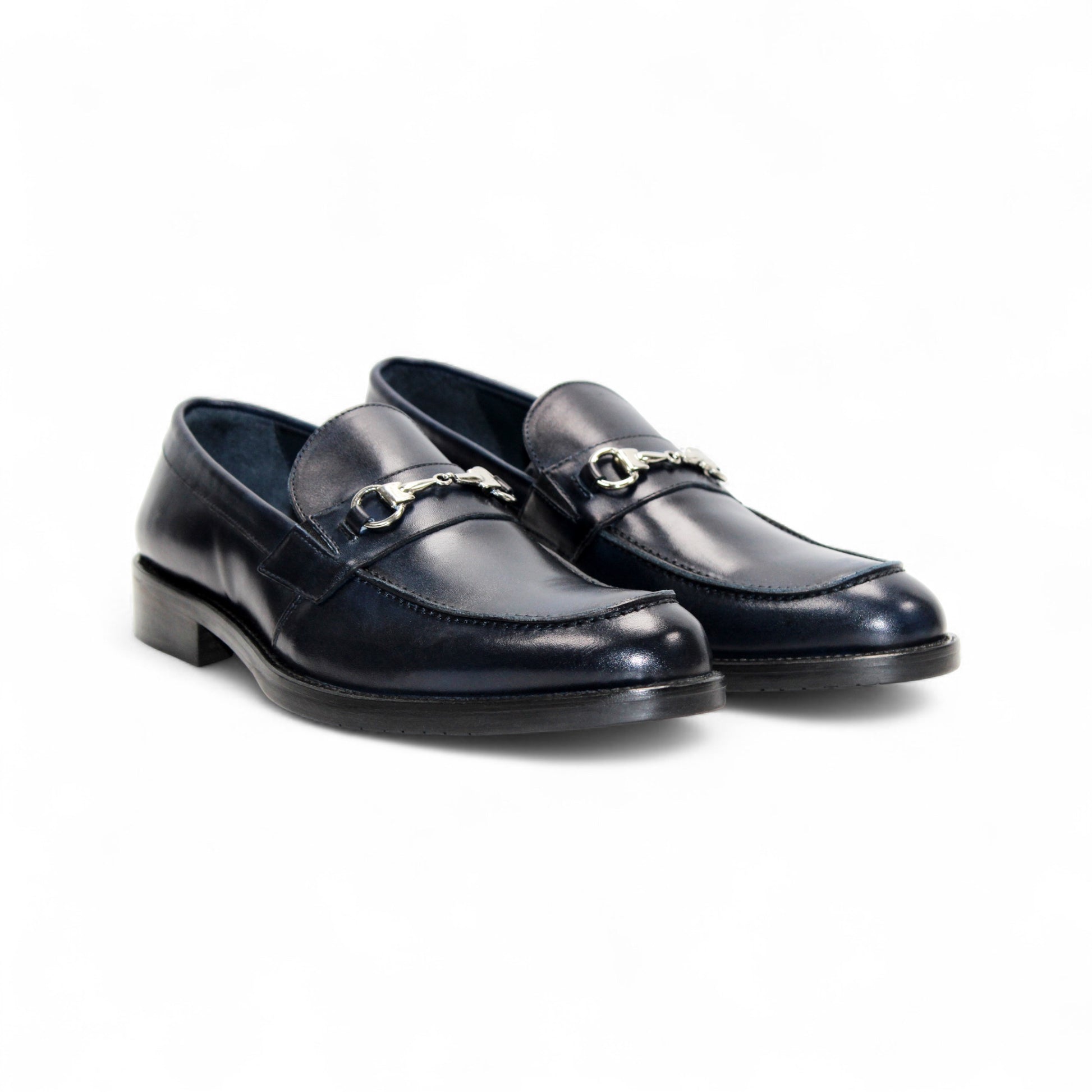 The Firmani Ben Navy by Firmani is a navy Italian leather loafer with a metal bit detail, low heel, and stitching accents, shown against a white background.