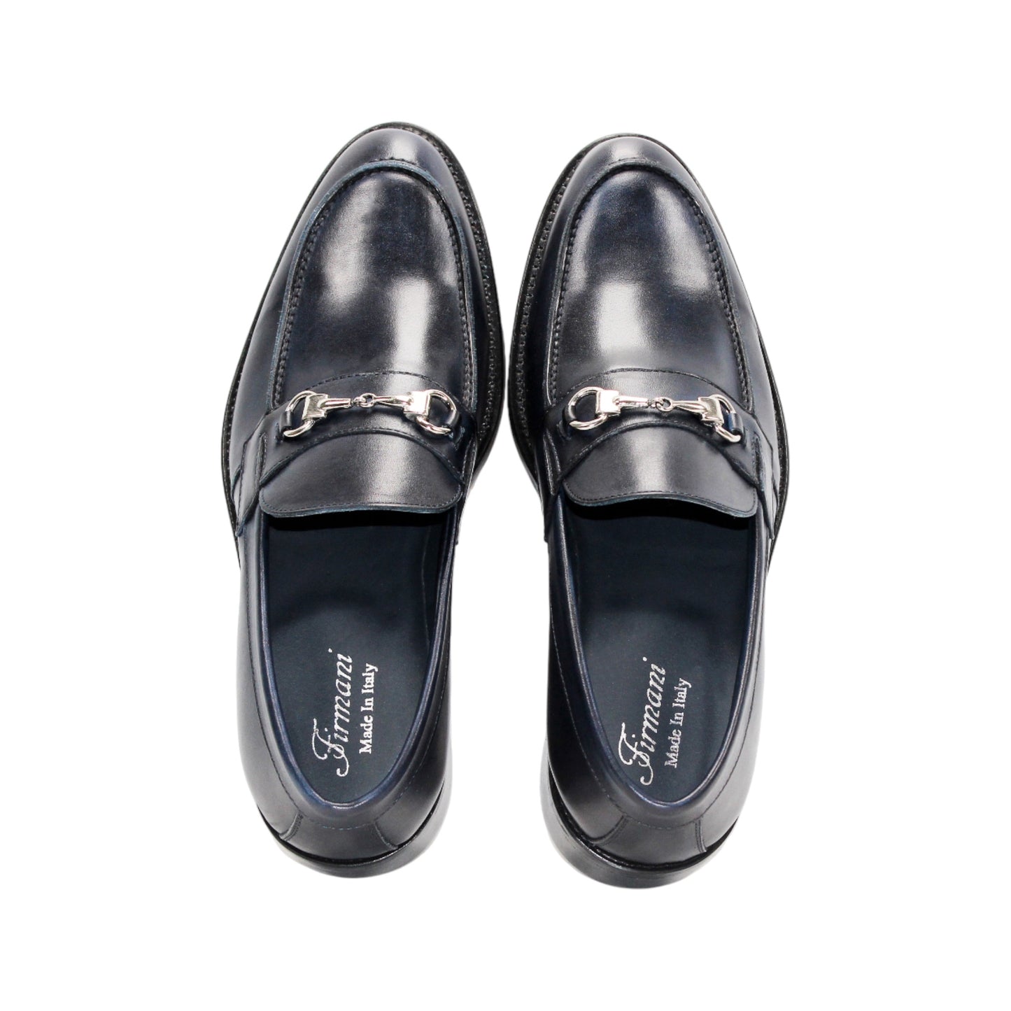 The Firmani Ben Navy by Firmani is a navy Italian leather loafer with a metal bit detail, low heel, and stitching accents, shown against a white background.