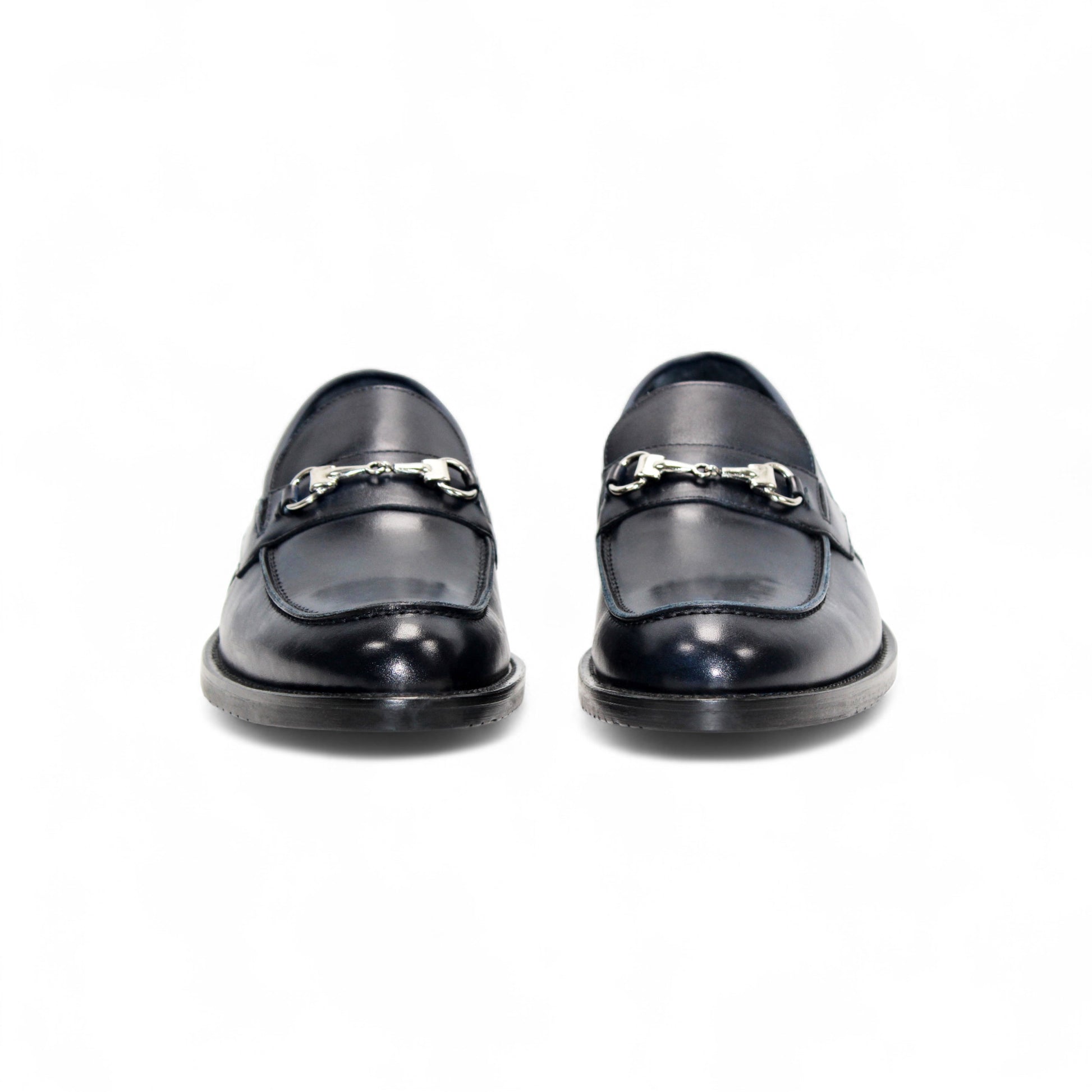 The Firmani Ben Navy by Firmani is a navy Italian leather loafer with a metal bit detail, low heel, and stitching accents, shown against a white background.