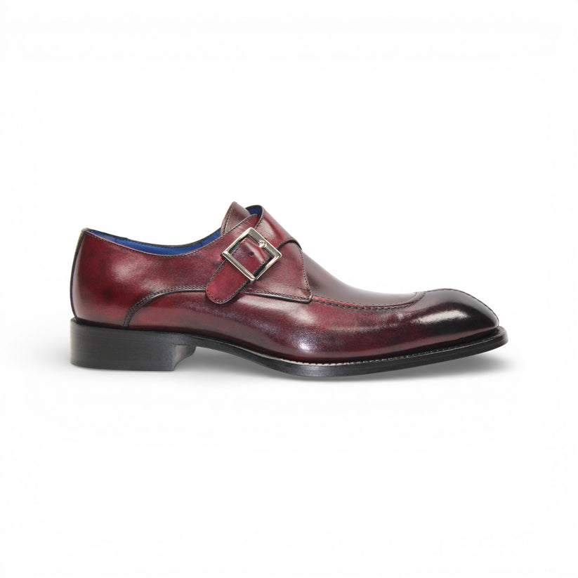 The Emilio Franco Bernardo Burgundy men's leather dress shoe features a silver buckle strap, black sole, and slight heel, stylishly displayed on a white background.