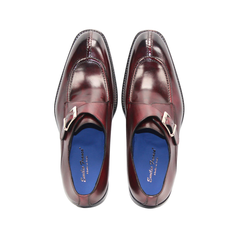 The Emilio Franco Bernardo Burgundy men's leather dress shoe features a silver buckle strap, black sole, and slight heel, stylishly displayed on a white background.